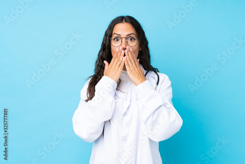 Young doctor woman over isolated blue background with surprise facial expression