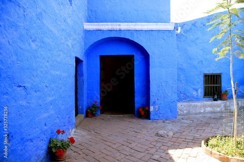 Doorway of the vivid blue old stone building inside Santa Catalina Monastery Complex, Arequipa, Peru © jobi_pro