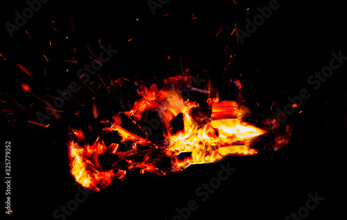 Coals burning in the dark as a background