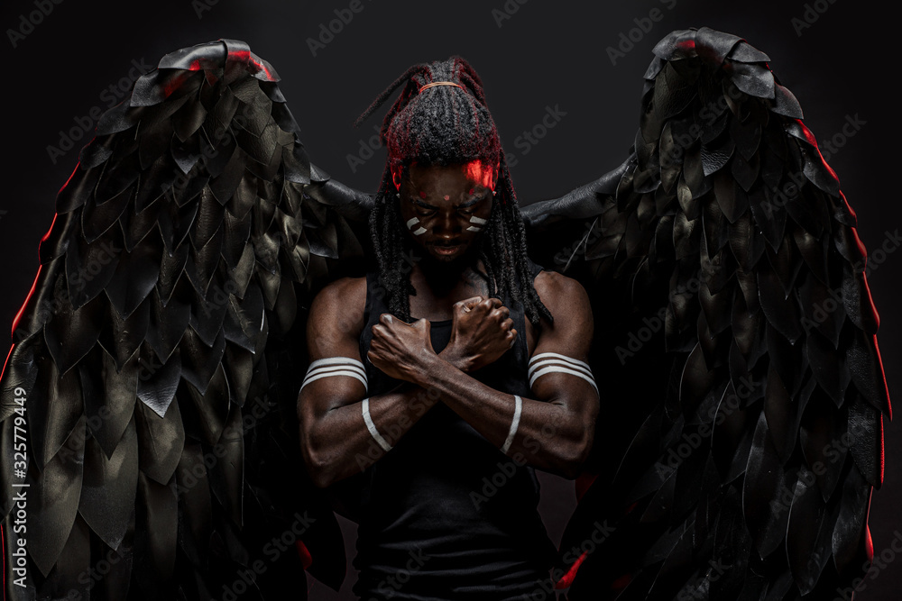 and fantastic dark angel having big black wings, african male