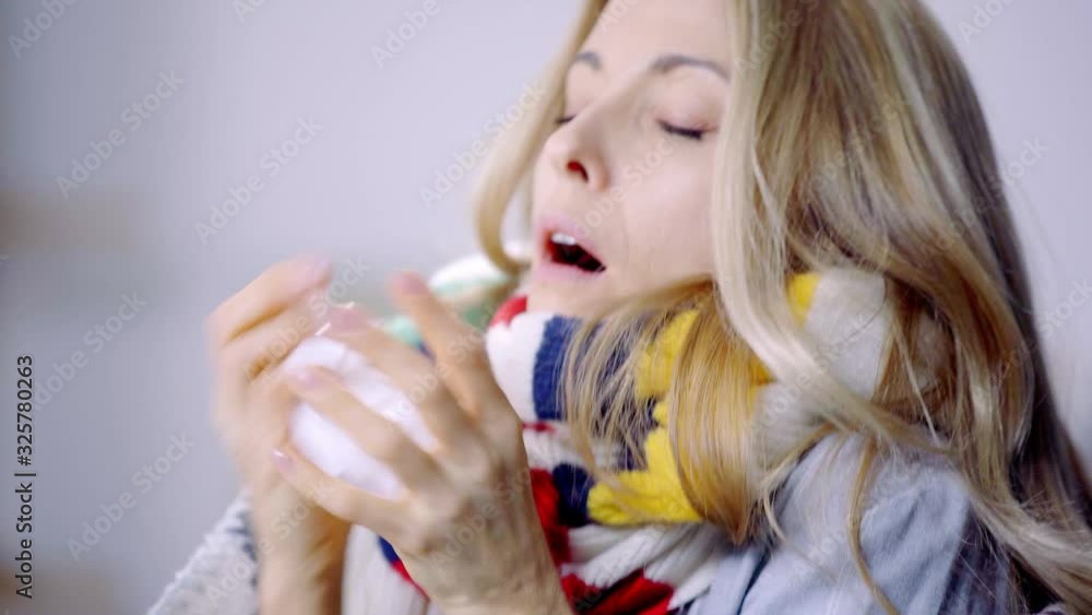 ill woman sneezing and using napkin ill woman sneezing and using napkin