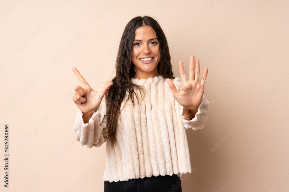 Young woman over isolated background counting seven with fingers Young woman over isolated background counting seven with fingers