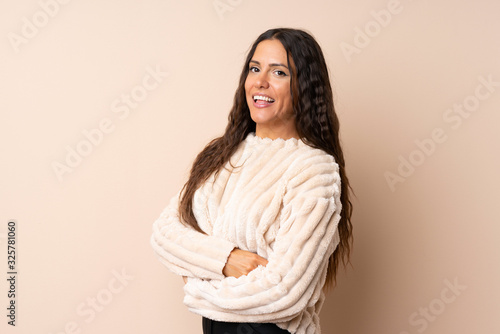 Young woman over isolated background with arms crossed and looking forward © luismolinero