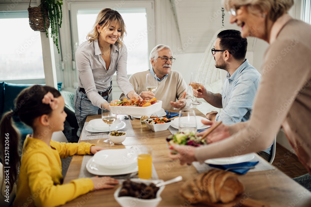 Happy extended family enjoying in lunch at dining table. Happy extended family enjoying in lunch at dining table.