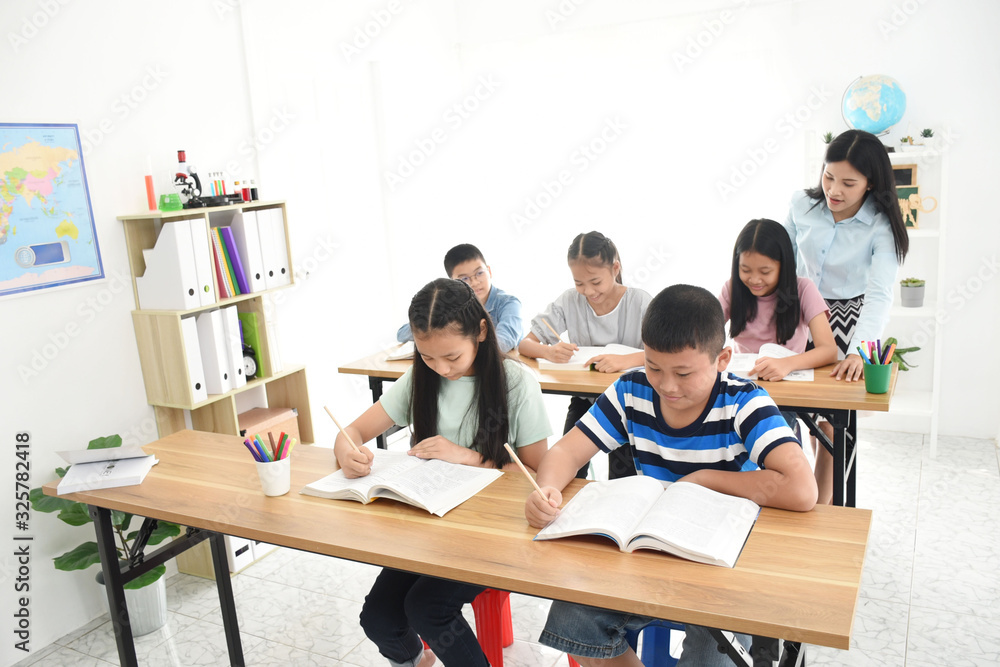 asian students group and teacher in the classroom