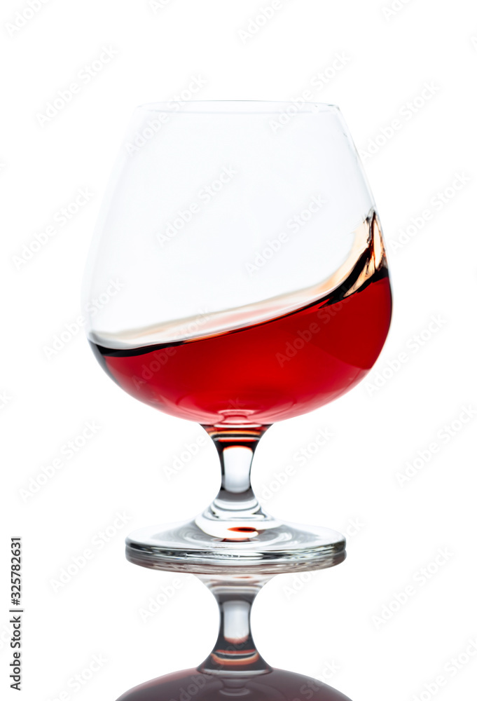 Splash of cognac in glass, isolated on white. Splash of cognac in glass, isolated on white.