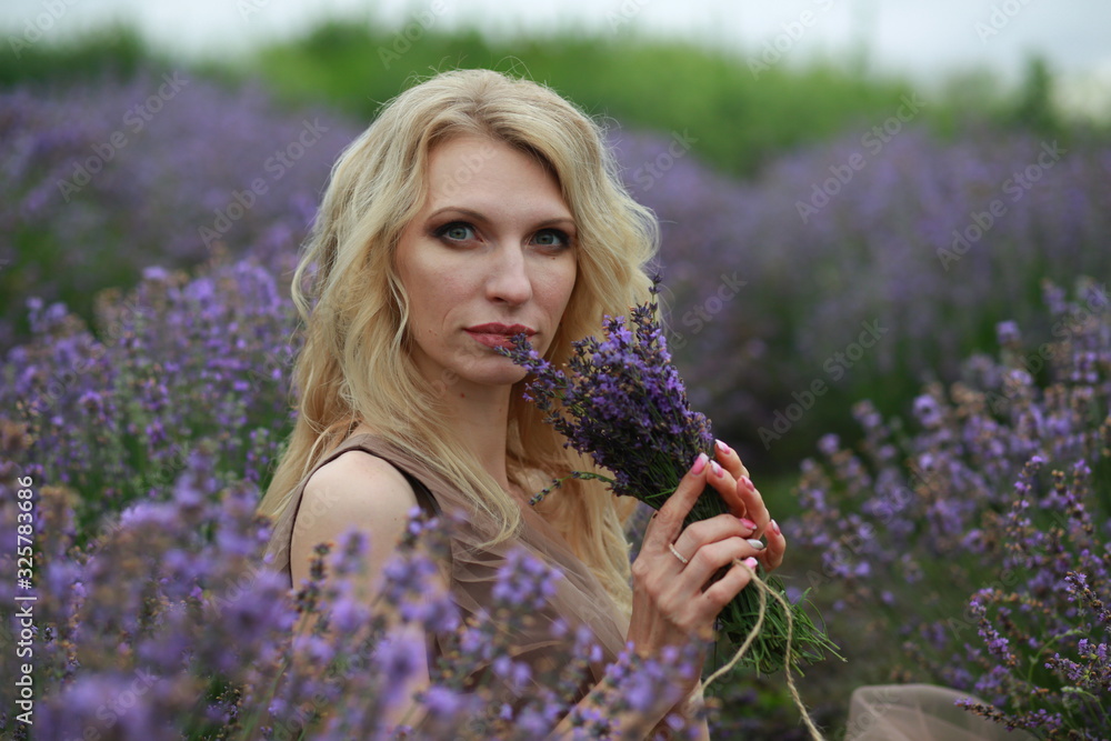 blonde girl in lavender field in summer enjoying vacation blonde girl in lavender field in summer enjoying vacation