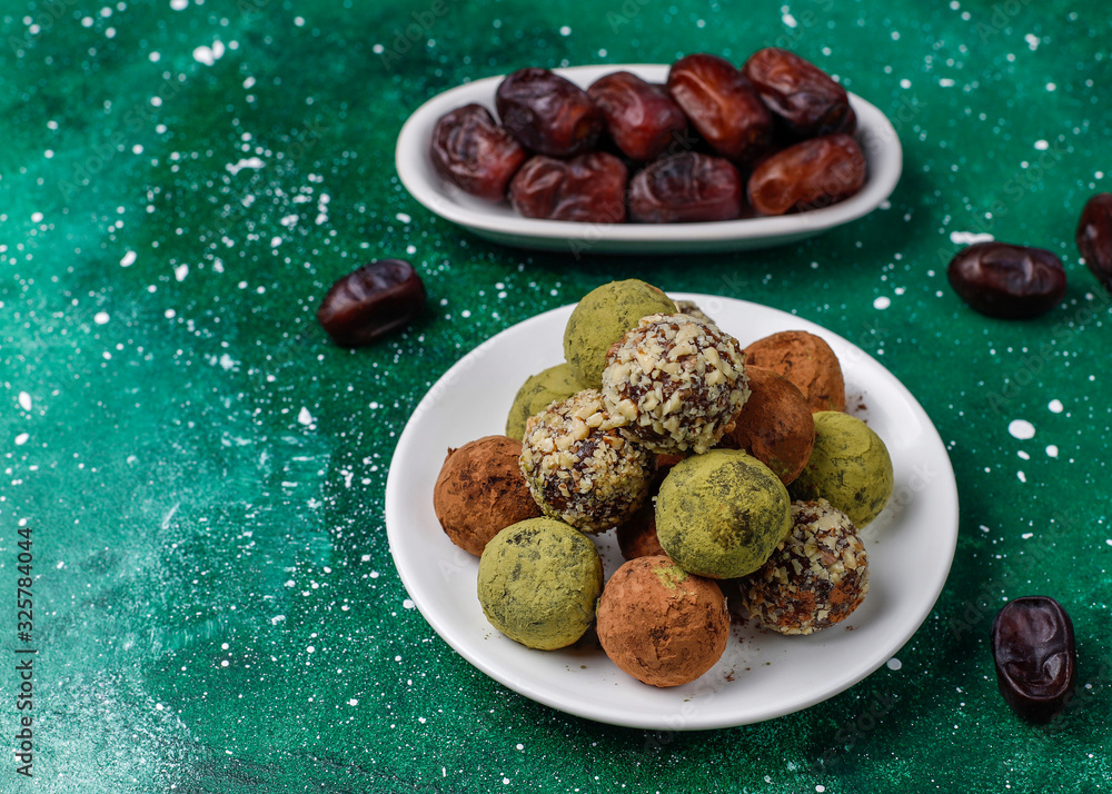 Homemade healthy vegan raw energy truffle balls with dates and walnuts,matcha powder,cocoa powder,top view Homemade healthy vegan raw energy truffle balls with dates and walnuts,matcha powder,cocoa powder,top view