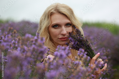  girl in lavender field in summer enjoying 