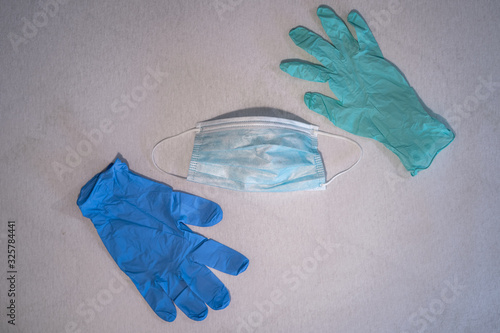 Blue surgical mask and gloves background. Medicine, healthcare and dentistry. Infection and spread protection and prevention. Coronavirus COVID-19 outbreak.