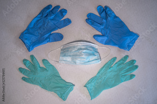 Blue surgical mask and gloves background. Medicine, healthcare and dentistry. Infection and spread protection and prevention. Coronavirus COVID-19 outbreak.