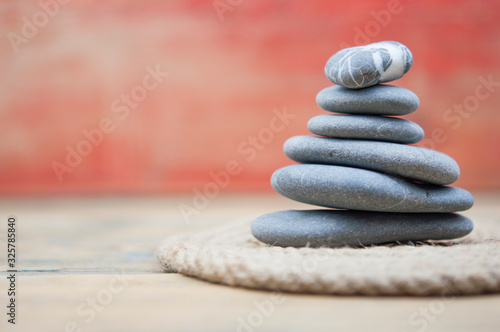Canvas Print Stack of stones on wooden table, space for text. Zen concept