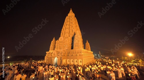 Wat Panyanantaram, a Buddhist temple in Pathum Thani City, Thailand. Architecture buildings in a ceremony where people walk with lighted candles in hand around the temple at night in Makha Bucha Day. photo