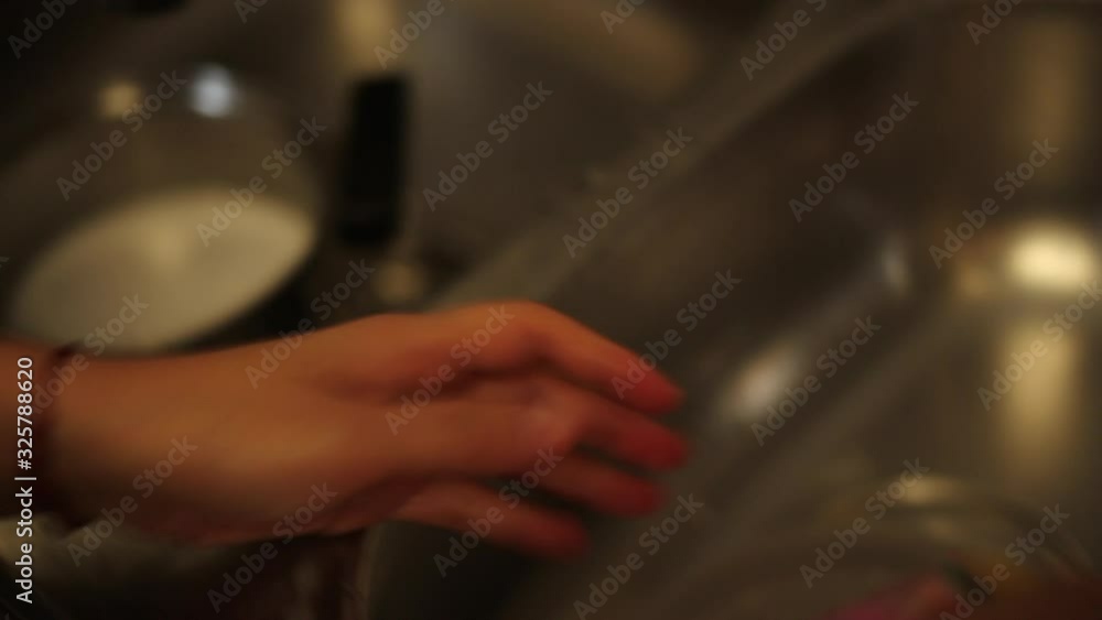 A housewife washing dishes in the kitchen A housewife washing dishes in the kitchen