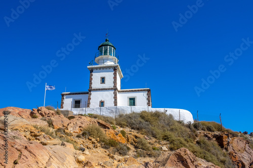 Greek Lighthouse Building on Blue Sky Background