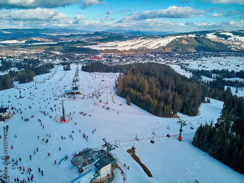 Beautiful panoramic aerial drone view to the ski slopes with lifts in the Bialka Tatrzanska ski resort Tatra Mountains (Tatras, Tatra) - mountain range between Slovakia and Poland
