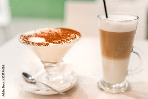 coffee latte with frothy milk in tall glass, rustic style, white background