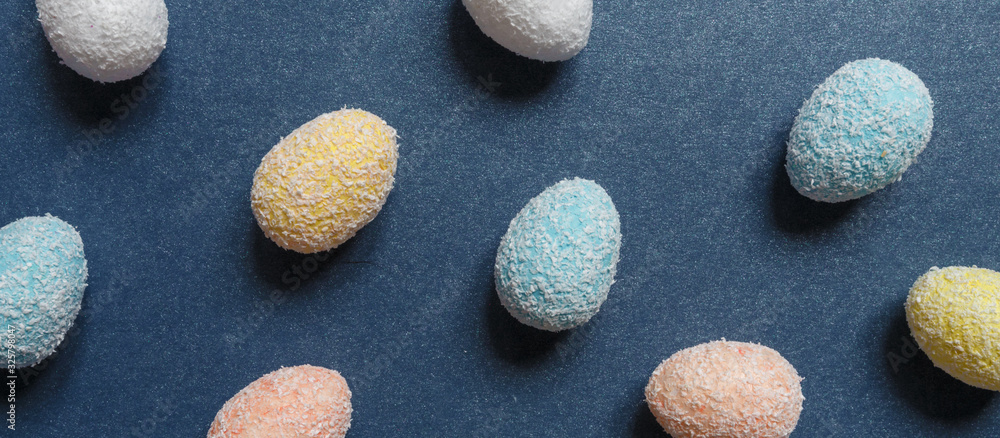 Easter flat lay background of colorful eggs on a blue background, Easter pattern top view with copy space. Easter flat lay background of colorful eggs on a blue background, Easter pattern top view with copy space.