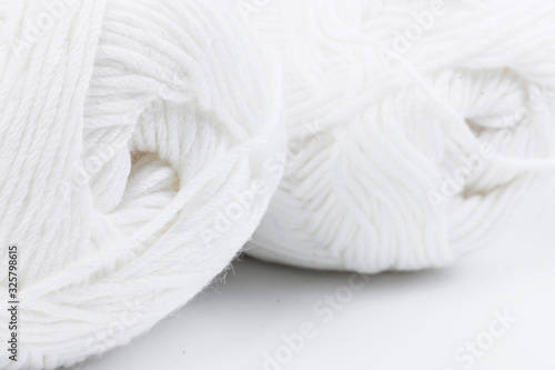 woolen white threads on white background. natural wool. knitting. background