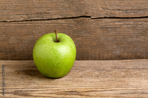 Green apple on a wooden background