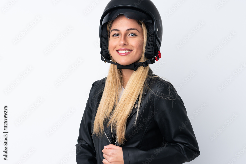 Young Uruguayan woman with a motorcycle helmet over isolated white background Young Uruguayan woman with a motorcycle helmet over isolated white background
