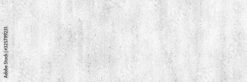 Concrete background.White painted wall with gray and dirty texture.Long light wall.