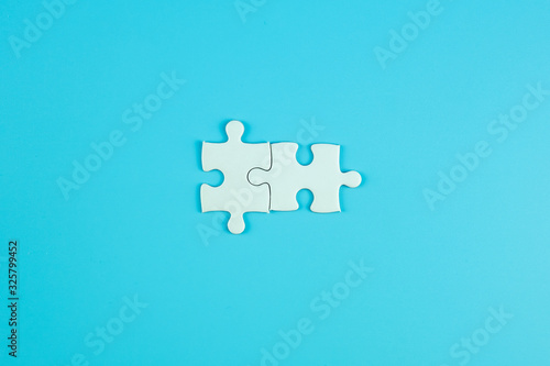 Jigsaw puzzle pieces on blue background with copy space for text. solutions, mission, successful, goals, cooperation, partnership and strategy concept