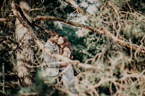 Kissing newlyweds couple. Outdoors wedding ceremony.