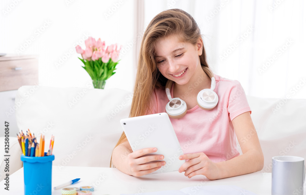 cute teen, browsing interesting articles on internet on her personal tablet computer cute teen, browsing interesting articles on internet on her personal tablet computer