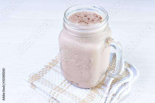 Cold base with refreshing chocolate drink on white wooden background