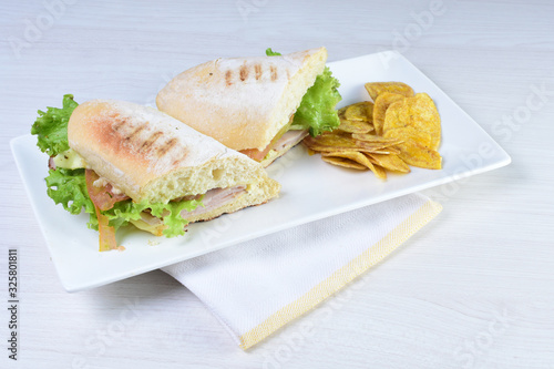 Ham and cheese sandwich on white wooden background