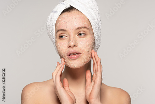 Fotografie, Obraz attractive girl with towel on head applying coconut scrub on face, isolated on g