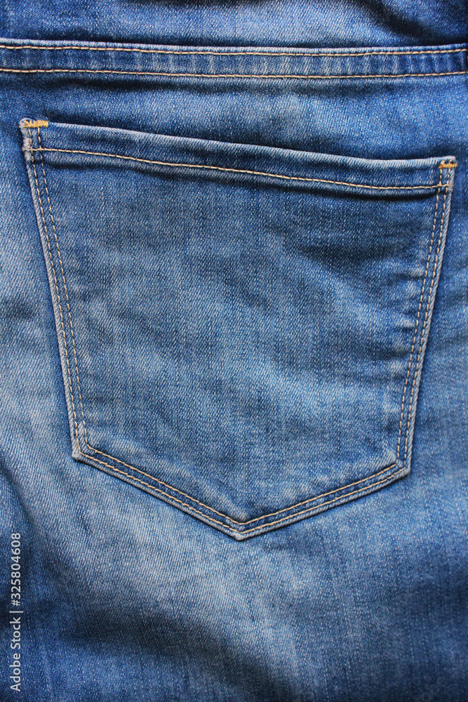 Jeans pocket backside view of plain light blue denim jeans fabric detail. Casual clothes fragment of pale blue jean pocket background Jeans pocket backside view of plain light blue denim jeans fabric detail. Casual clothes fragment of pale blue jean pocket background