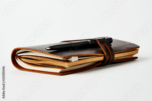 Business contact book and pen, close-up