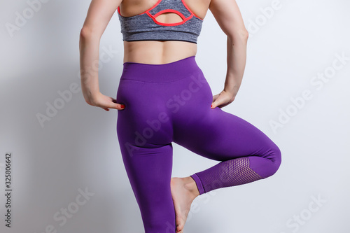 Beautiful Dieting Fat Woman who practices Fitness for Weight Loss Does Stretching Exercises on an Isolated Background with Space for Advertising photo