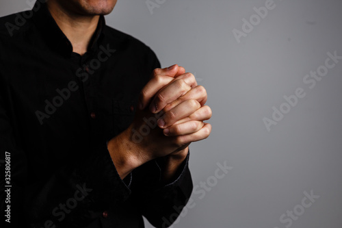 Φωτογραφία Praying Hands on a black background