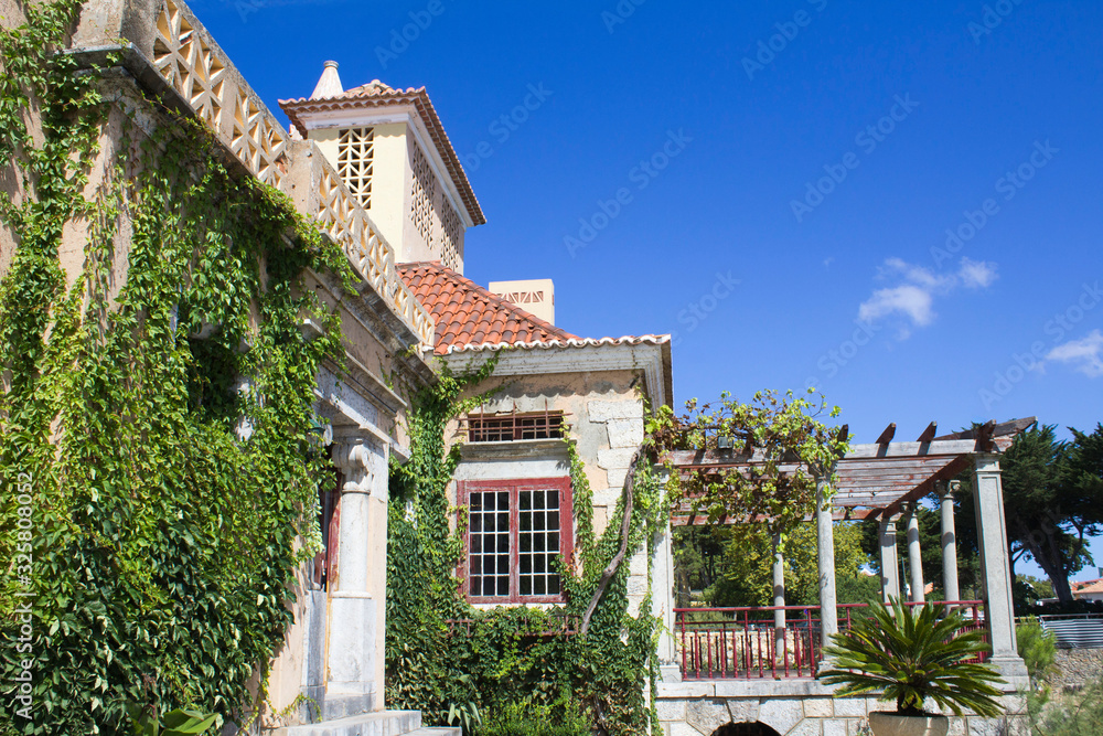 Beautiful view of the old villa or castle on a summer day. Traditional old architecture. Cascais. Portugal.