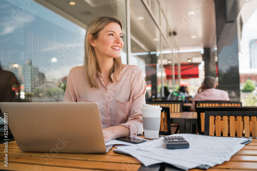 Young businesswoman working on her laptop. © Mego-studio