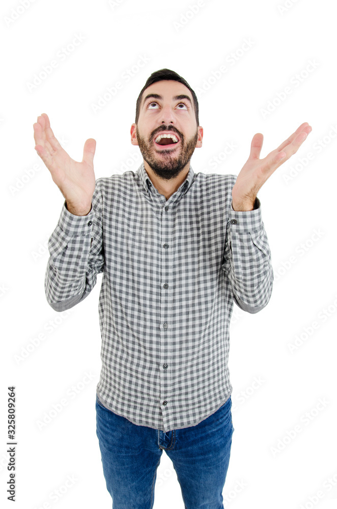 Portrait of fascinated excited young guy looking up with happy expression and raising arms, standing over white background. Boyfriend sings to gilfriend while standing near her balcony Portrait of fascinated excited young guy looking up with happy expression and raising arms, standing over white background. Boyfriend sings to gilfriend while standing near her balcony