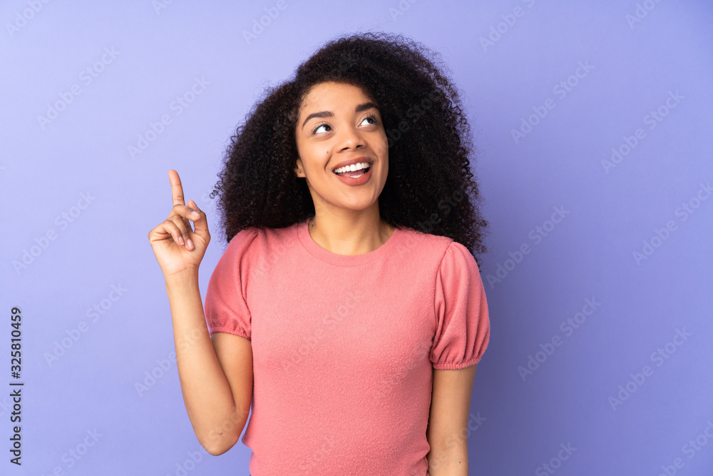 Young african american woman isolated on purple background intending to realizes the solution while lifting a finger up Young african american woman isolated on purple background intending to realizes the solution while lifting a finger up