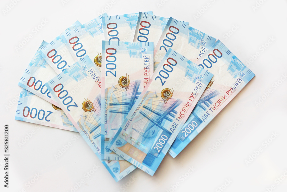 Background of russian money. Banknotes of two thousand roubles laying on table. Top view photo of banknotes. Finance and investment concept Background of russian money. Banknotes of two thousand roubles laying on table. Top view photo of banknotes. Finance and investment concept