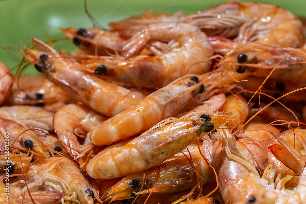Fresh big orange shrimps baked on the grill looks appetizing Fresh big orange shrimps baked on the grill looks appetizing