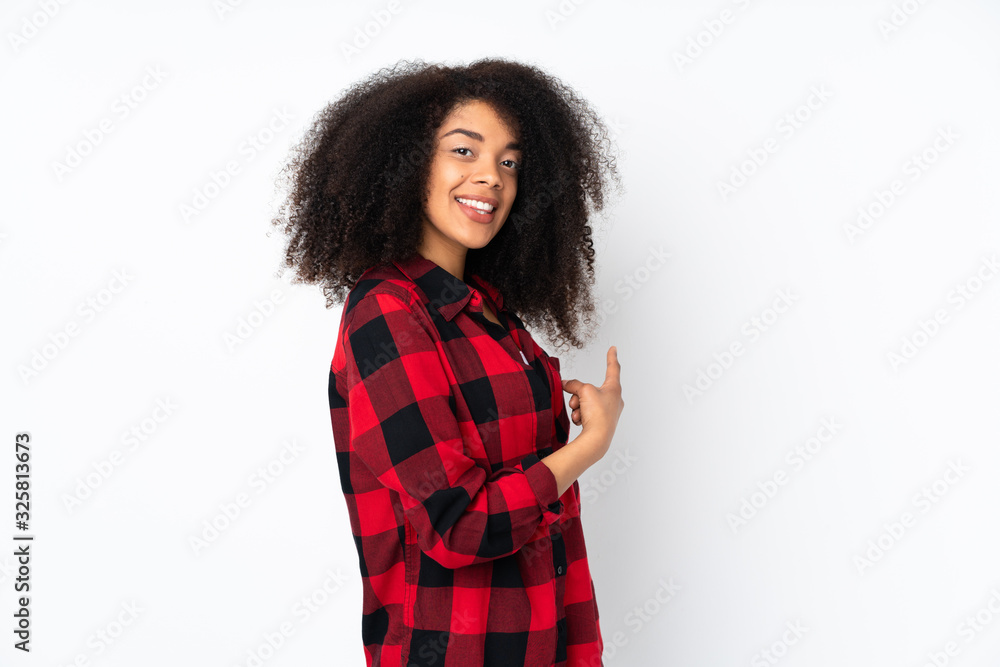 Young african american woman over isolated background pointing back Young african american woman over isolated background pointing back