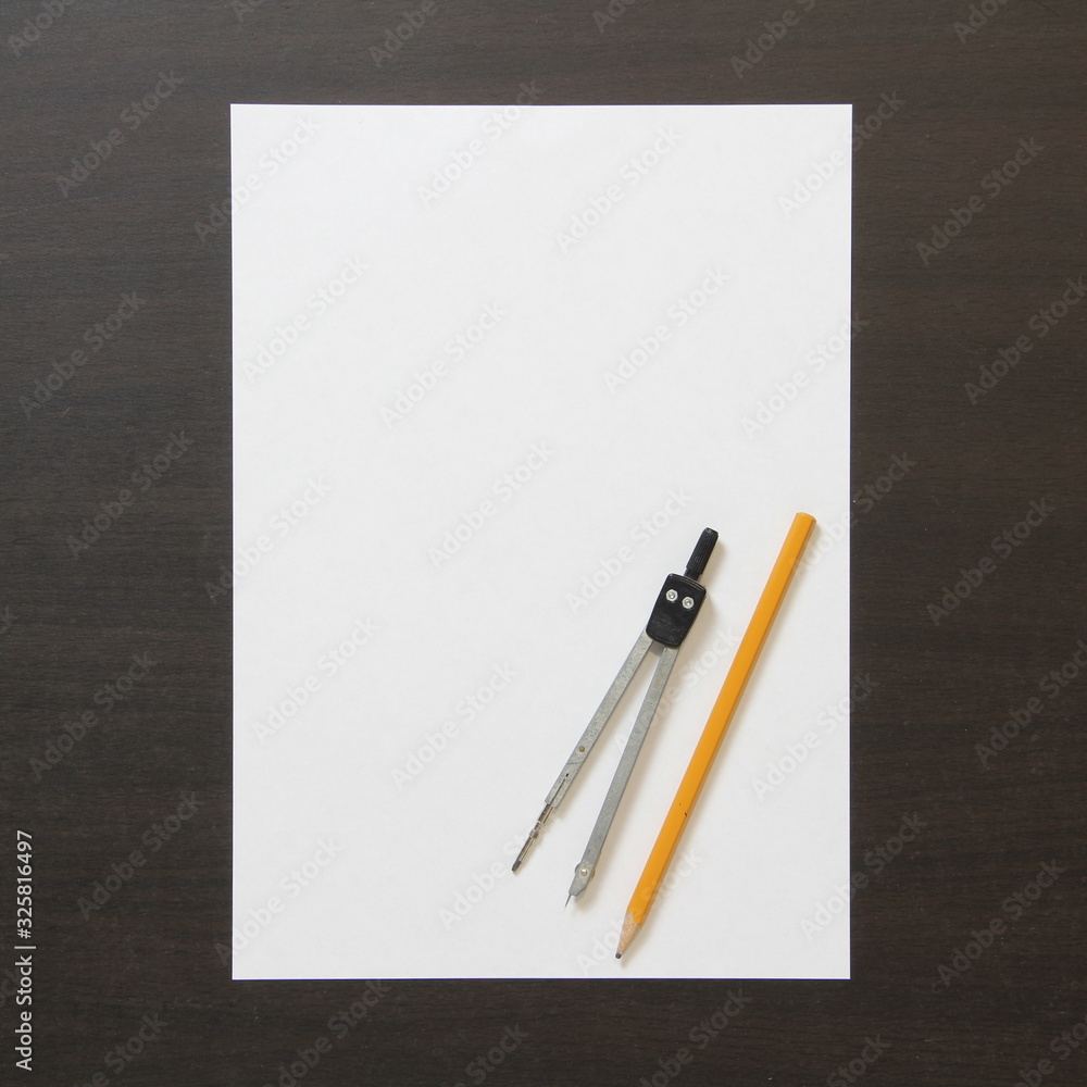 Template of white paper, divider and pencil on dark wenge color wooden background. Template of white paper, divider and pencil on dark wenge color wooden background.