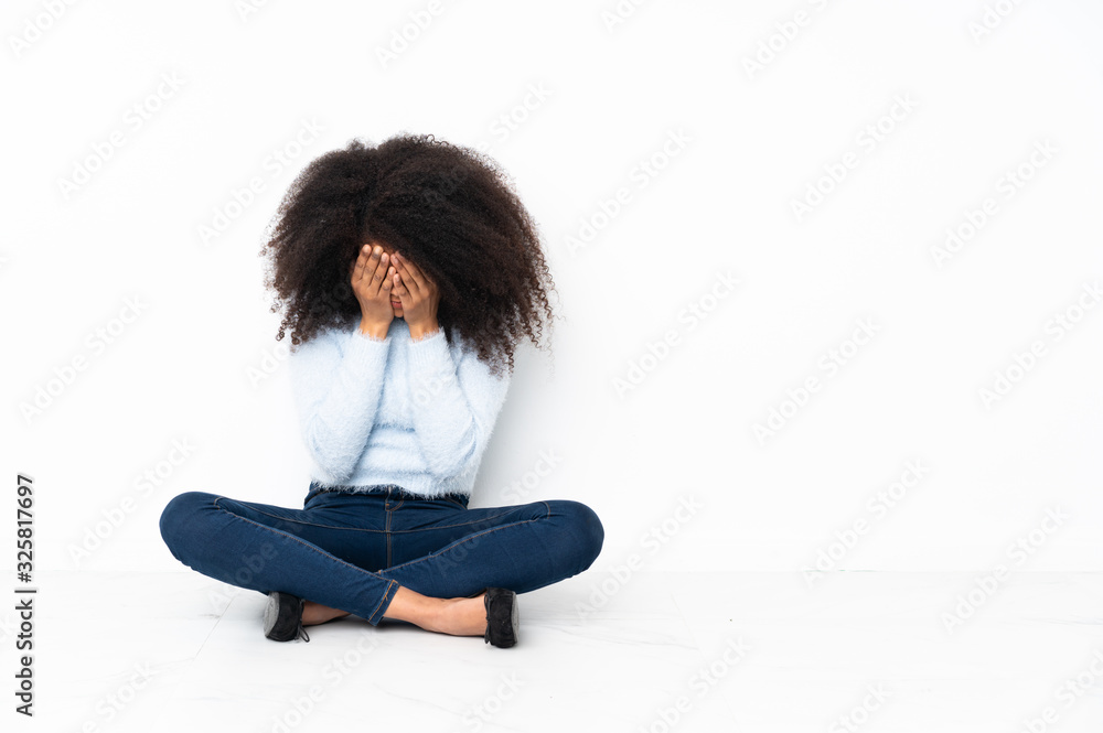 Young african american woman sitting on the floor with tired and sick expression Young african american woman sitting on the floor with tired and sick expression