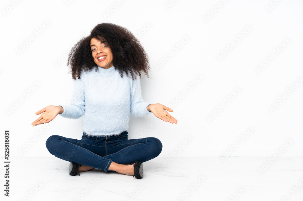 Young african american woman sitting on the floor smiling Young african american woman sitting on the floor smiling