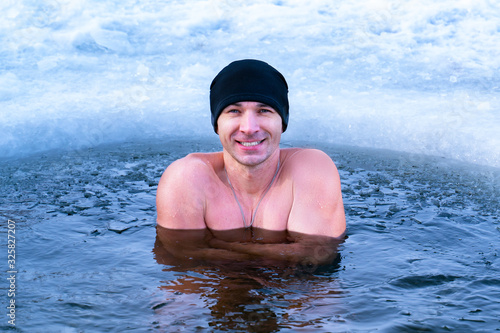 Hardening the body from diseases in cold water. Winter swimming in the ice hole.