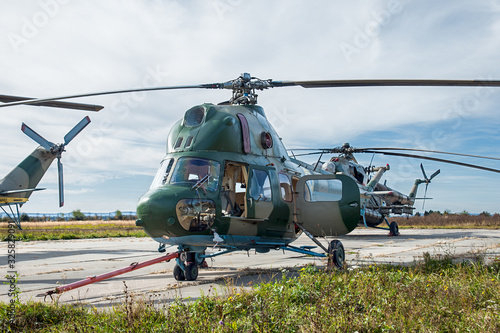 group of helicopters on military air base