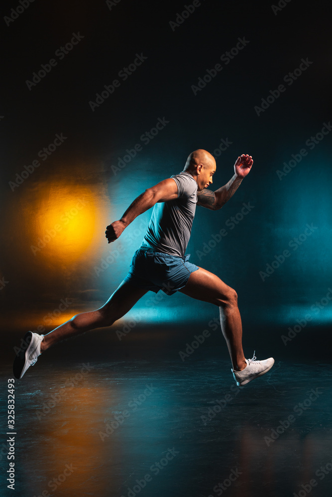 Professional sportsman running fast indoors stock photo