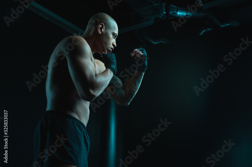 Shirtless young man in boxing stance stock photo